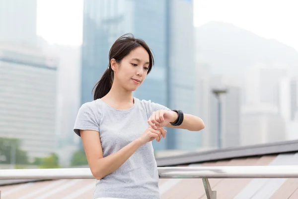Woman checking the data on sport watch