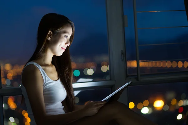 Woman with tablet pc at night