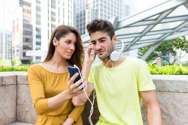 Young caucasian couple listen to music