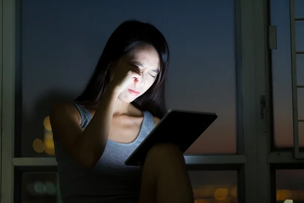 Woman with tablet feeling eye pain