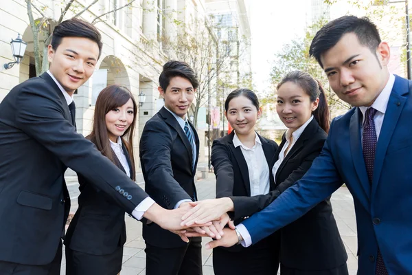 Business people joining hands together
