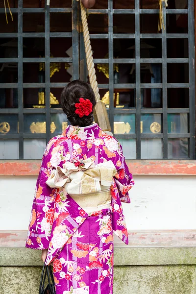 Woman pull the rope to ring the bell