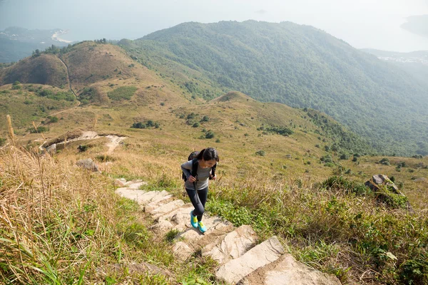 Asian woman hiker climb mountain