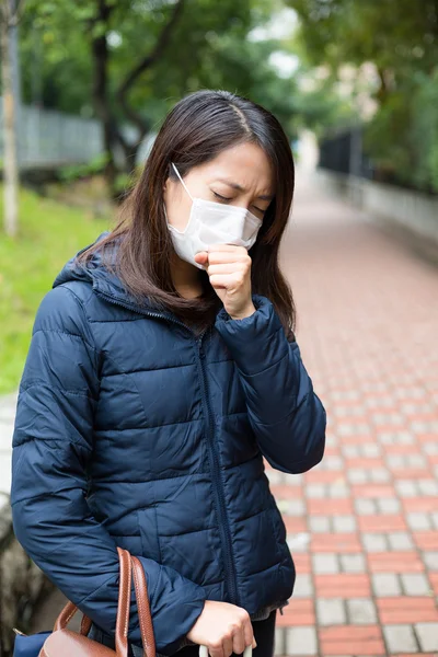 Asian woman sick and wearing face mask