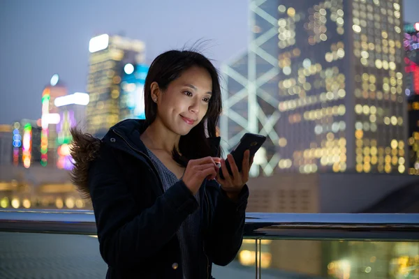 Woman using mobile phone in Hong Kong
