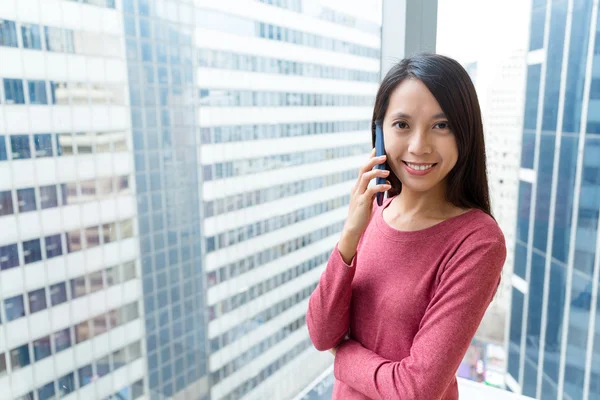 Asian woman talking on mobile phone