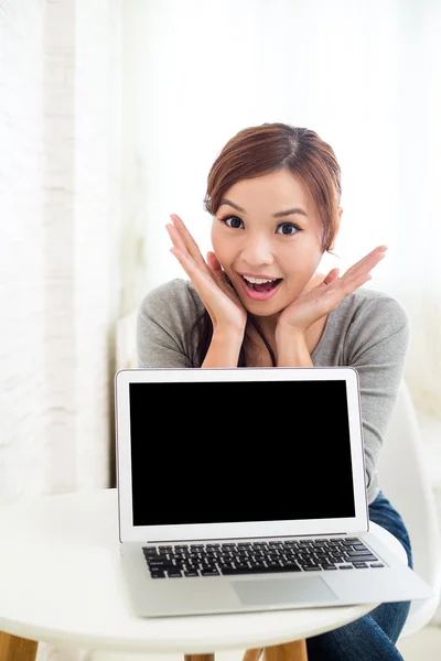 Woman showing blank laptop screen
