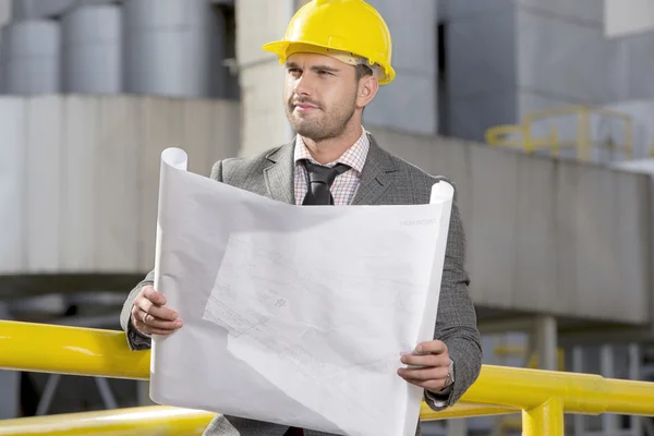 Engineer holding blueprint