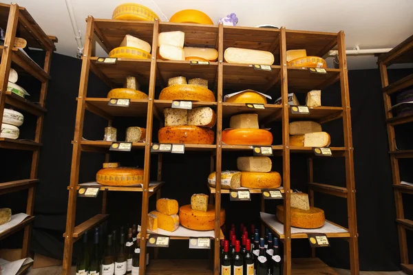 Cheese arranged on shelves