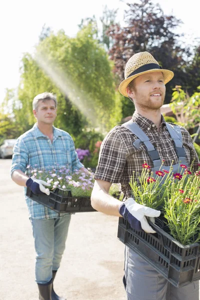 Gardeners carrying flower pots