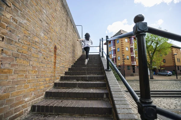 Woman walking up stairs