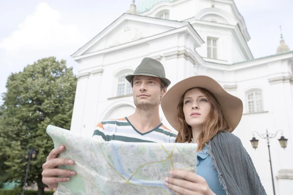 Couple holding map outside St. Casimir Church
