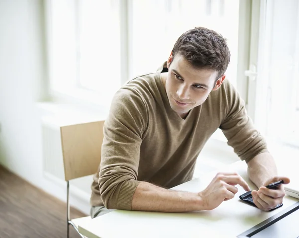 Businessman holding cell phone