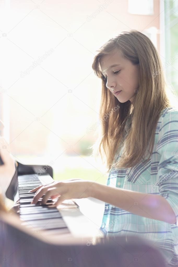 Teen Girl Playing Piano