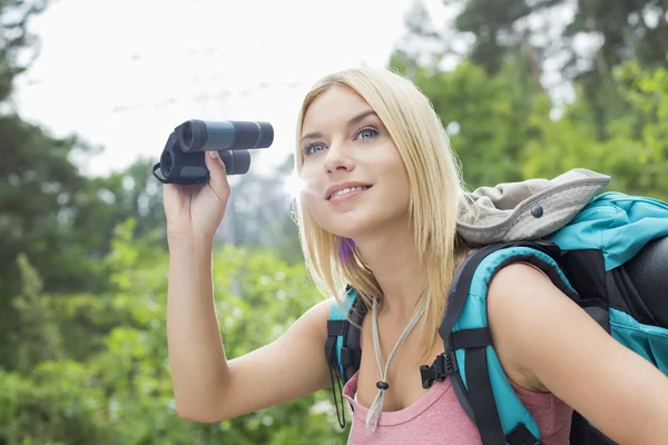 Female hiker using binoculars