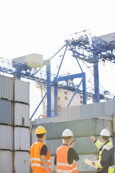 Workers inspecting cargo containers