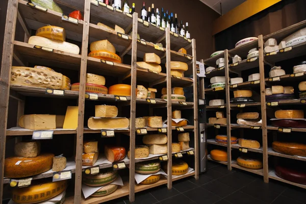 Cheese arranged on shelves