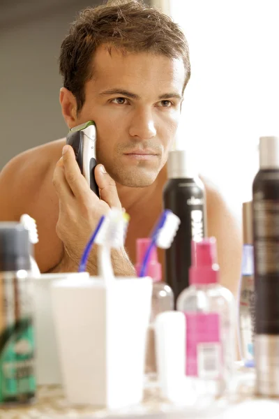Man in mirror shaving