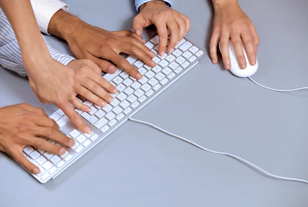 Human hands on computer keyboard