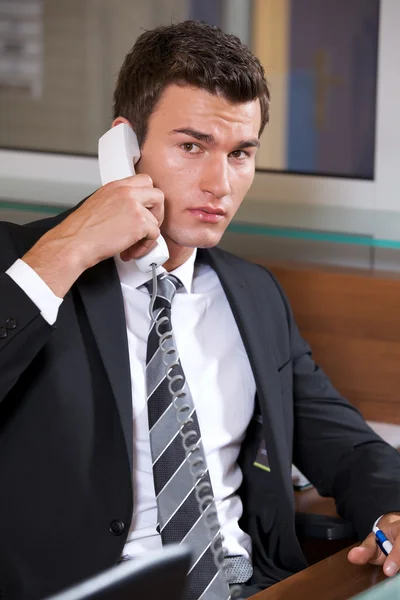 Businessman conversing on phone