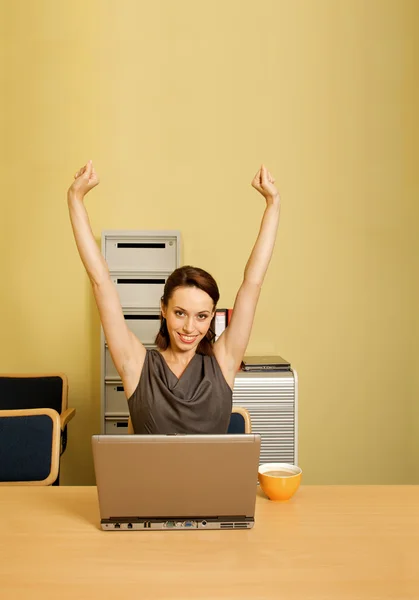 Businesswoman with arms raised