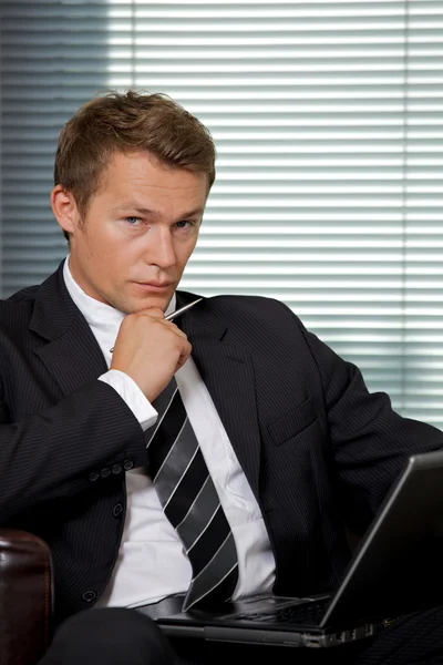 Businessman sitting with laptop