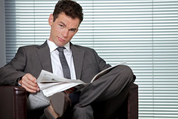 Businessman holding newspaper