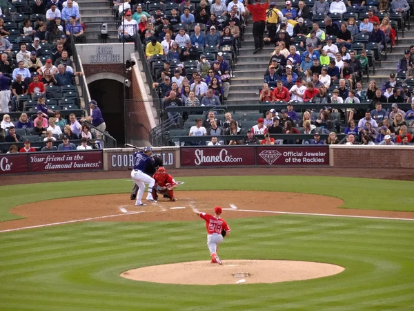 Angels pitcher Andrew Heaney throws pitch to Rockies batter Carl