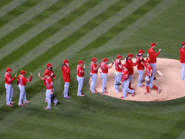 Angels players high five in infield after winning game