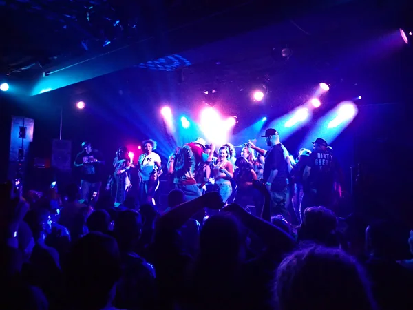 Ghostface Killah of Wu Tang clan dances on stage with crowd of w