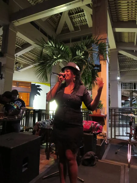 Female singer from Guidance Band sings on stage at Mai Tai Bar
