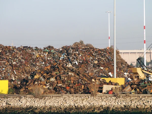 Pile of trash at Recycling processing facility along shore