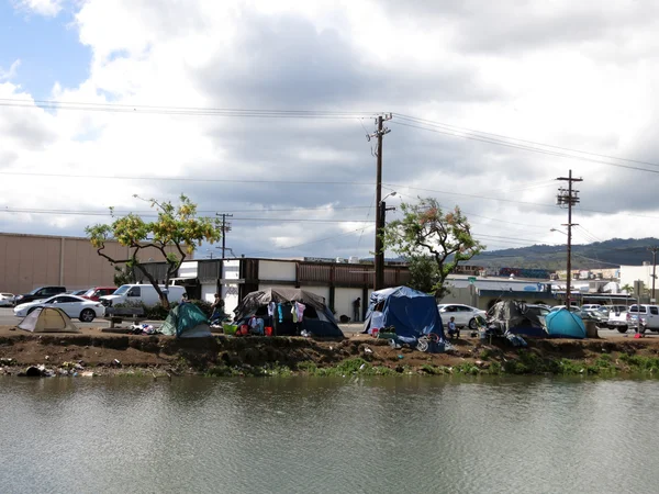 Homeless tents and cars parked along the Kapalama Canal