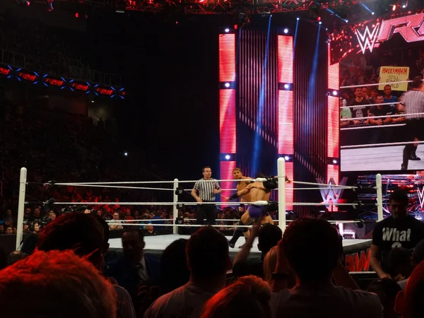 AxelMania throws punches at neville in the turnbukle during matc