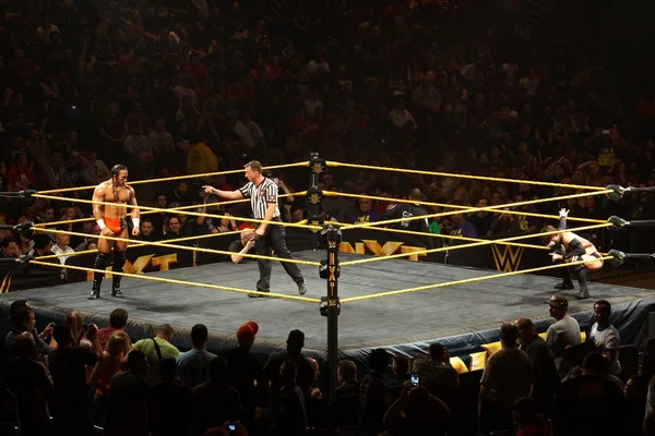 NXT male wrestler Adrian Neville stares across ring at Finn Balo