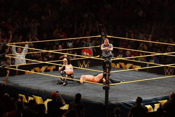 Ref points with both hands after NXT male wrestler Finn Balor be