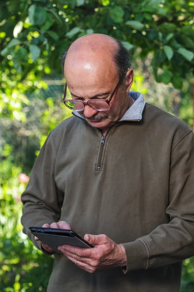 Elderly man with a bald head, mustache and glasses learn to deal