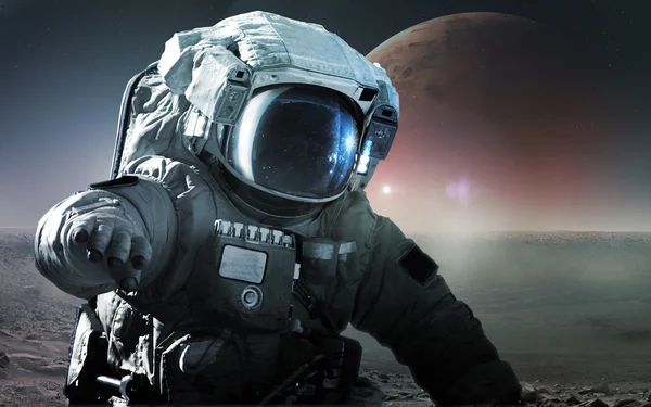 Astronaut walking on an unexplored planet. Elements furnished by NASA