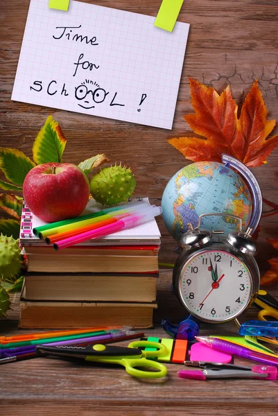 Time for school concept with text on wooden background