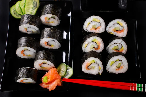 Sushi set on black plates