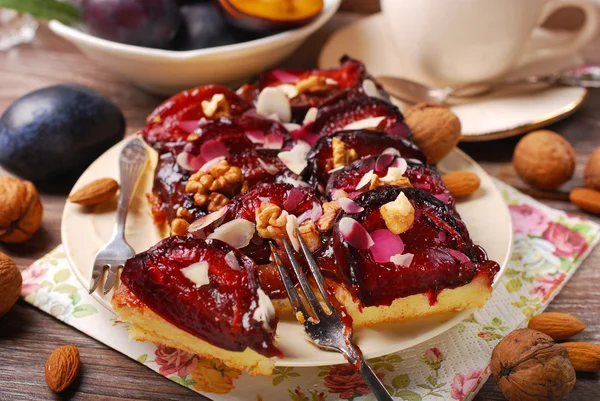 Homemade plum cake with walnuts and almonds