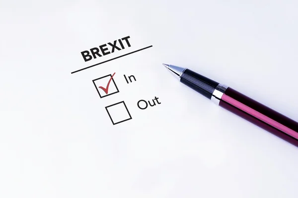 Tick placed in In check box on Brexit form with a pen on isolated white background. Brexit UK EU referendum concept