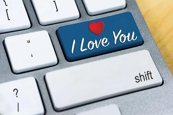 Written word I Love You and Heart Shape on blue keyboard button.