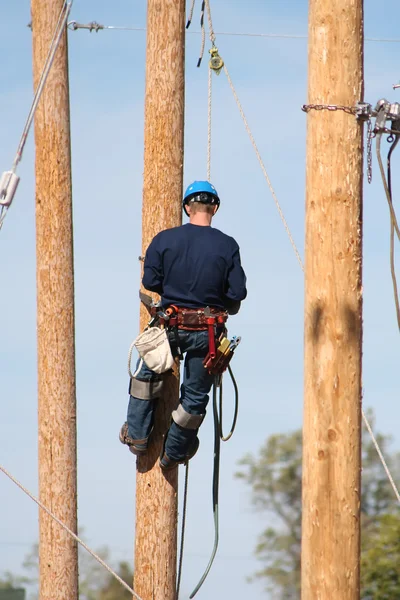 Electrical lineman working on line