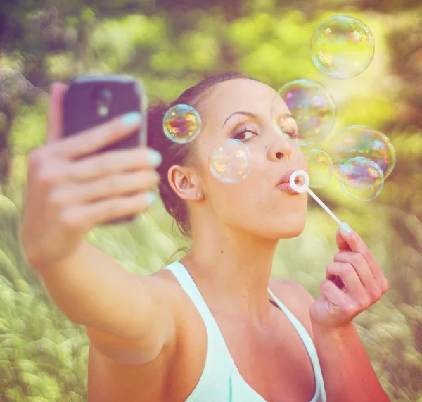 Pretty girl blowing bubbles