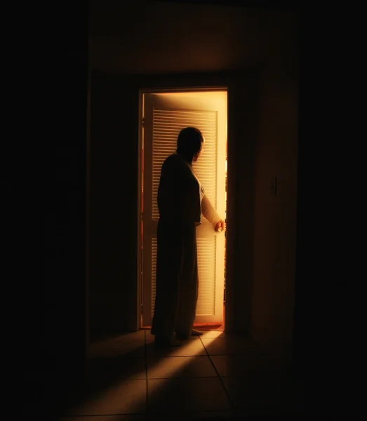 Person outside a bedroom door