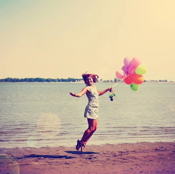 Woman with bunch of balloons