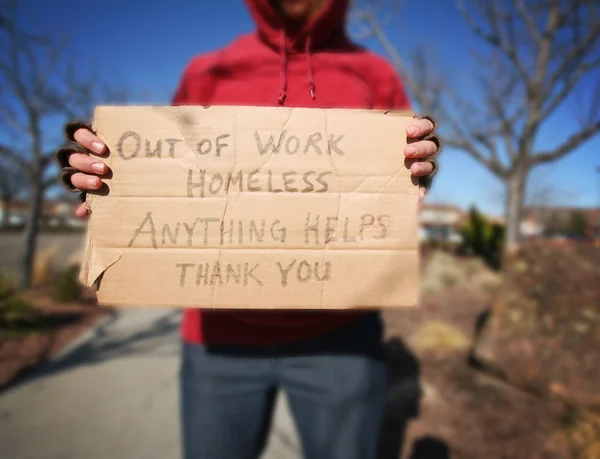 Homeless person with sign