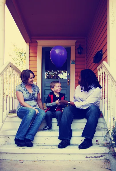 Cute family sitting on porch