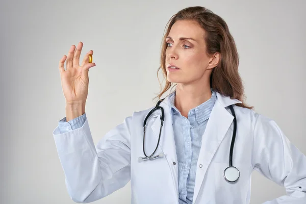 Female doctor holding pill vitamin